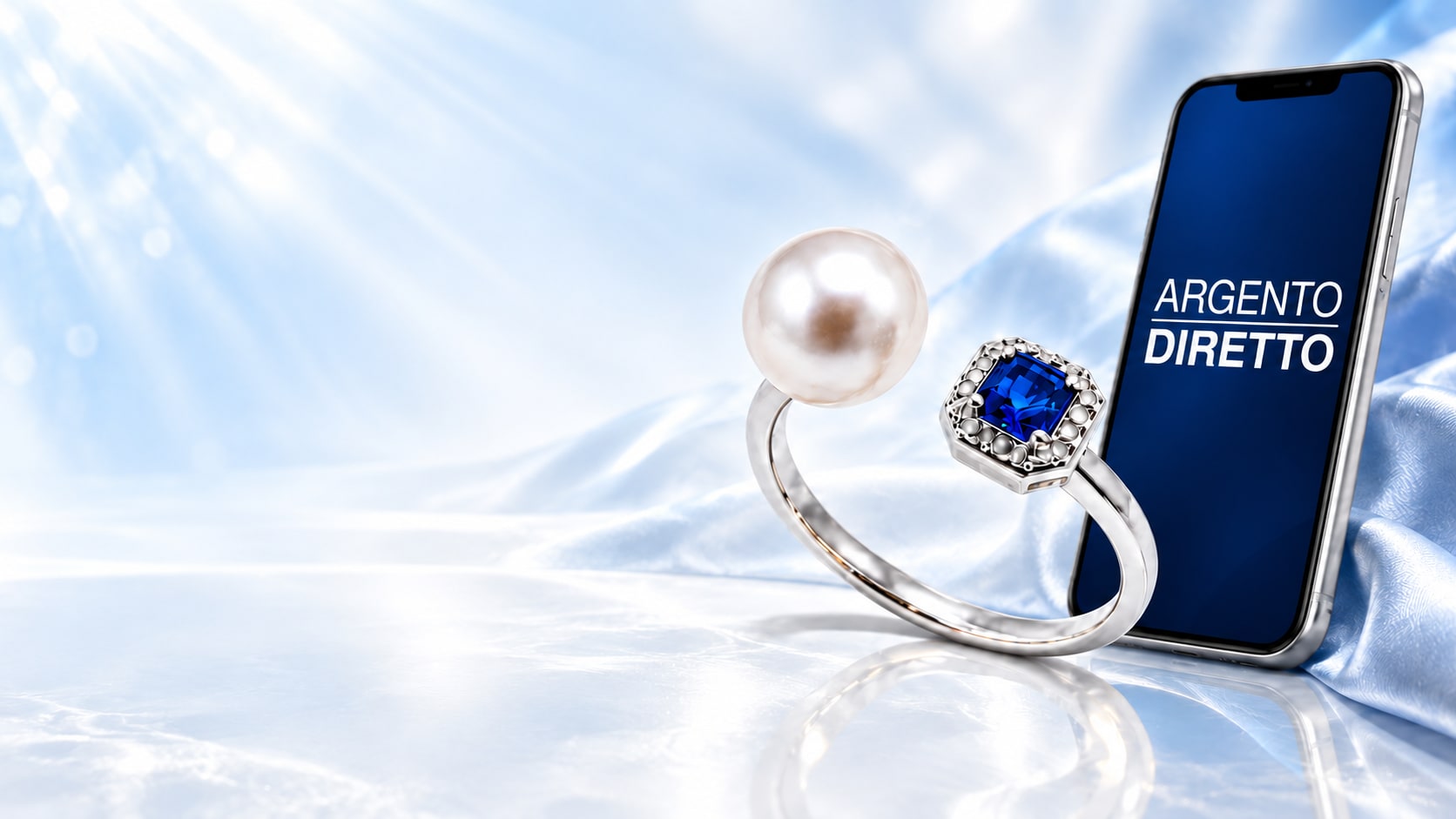 Anello in argento con perla e pietra blu accanto a uno smartphone Argento Diretto